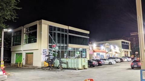 A gas station construction project shown at night. 