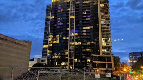 An active demolition site near a busy street in Atlanta with a high rise next door. 