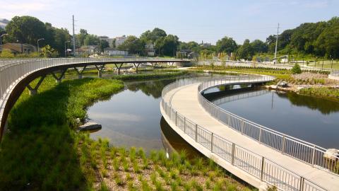 A photo of two long bridges over a pond in a new Atlanta park. 
