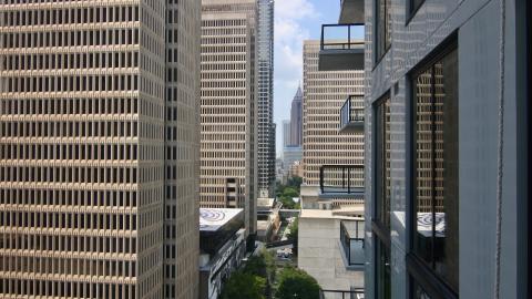 A row of skyscrapers in downtown Atlanta as seen from a gray apartment tower. 