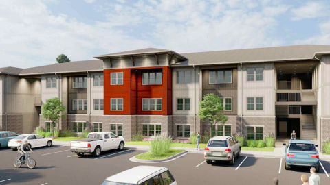 A red and tan building in a parking lot that will house affordable housing south of Atlanta. 