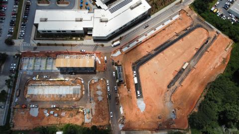 An aerial view of a large construction project in red clay. 