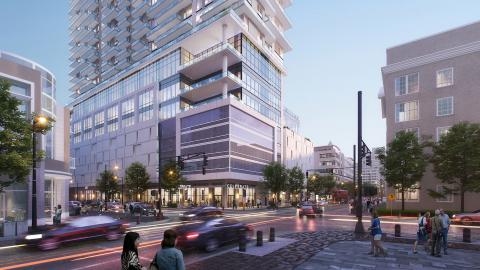 The based of a tall building on a busy Atlanta street with cars going by, in renderings. 
