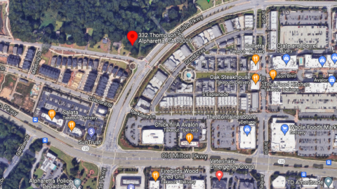 An overview of a large project site with trees in the Atlanta suburbs, next to a new mini city. 