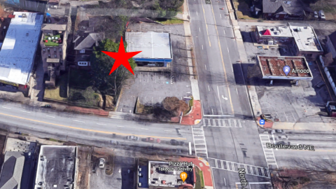 An overview of a corner lot where an old building and a house will be turned into a Starbucks. 