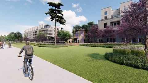 A rendering of a man riding a bike next to new apartment buildings under blue skies.