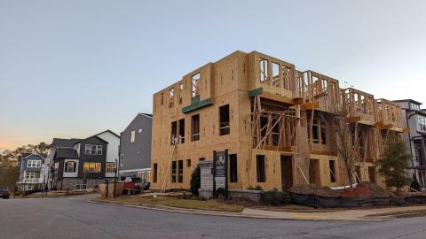 An under-construction townhome community under blue skies in Decatur Georgia. 