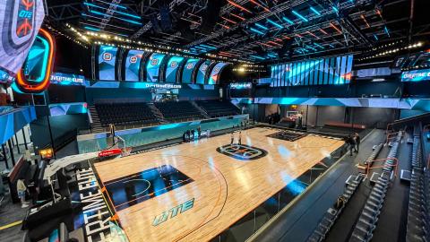 A large basketball gym in Atlanta with blue and orange lighting. 