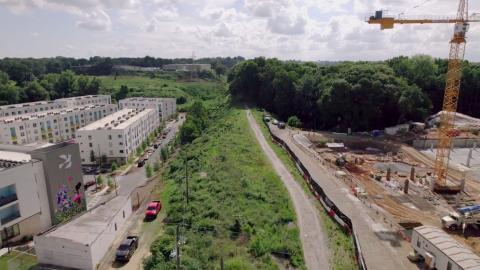 A drone photo of an unbuilt section of the Atlanta BeltLine with trees all around.  