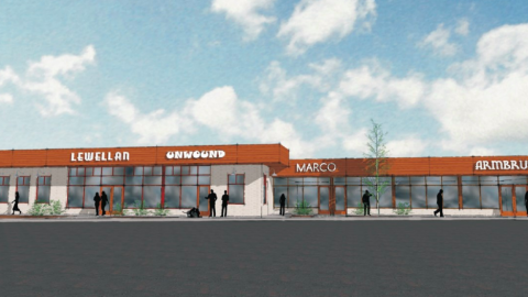 A rendering of a one-story retail property under blue skies. 