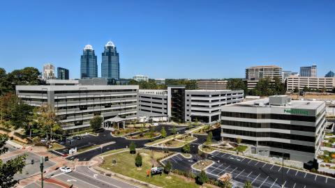 An overview of an office complex with concrete walls in suburban Atlanta under blue skies. 