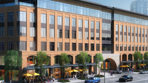 A rendering of a long low office building with shops at the base in Atlanta. 