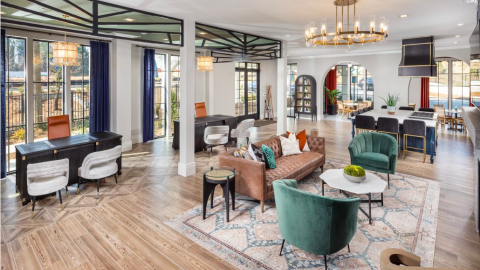 A photo inside a new apartment complex in Atlanta with white walls and wood floors.