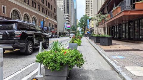 A photo showing big leafy planters in a traffic lane in downtown Atlanta. 