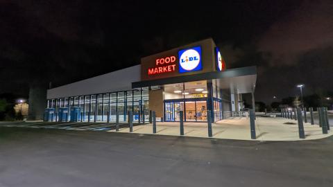 A photo of a grocery store at night in a large parking lot in Atlanta. 