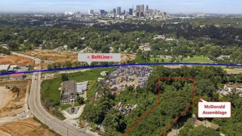 An aerial photo of huge development sites along a wide street south of downtown Atlanta.