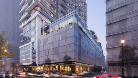 A rendering of a glassy new tower in Midtown Atlanta with white buildings beyond and blue skies above.