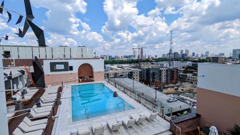 A photo of a large rooftop in Atlanta with a pool and many chairs. 