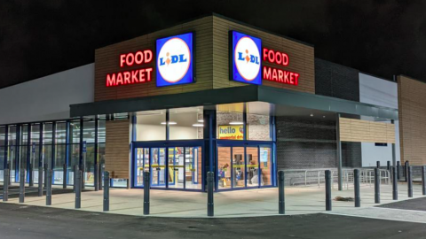 A photo of a new grocery store at night under black night skies. 