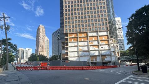 A photo of a large building with missing base floors under a blue sky in Atlanta.