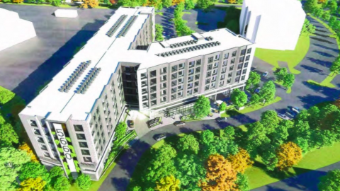 A rendering of a gray concrete new apartment complex proposed in an office park among many trees.