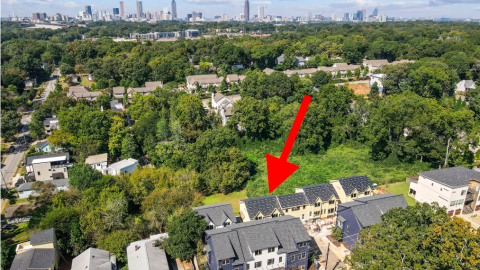 A photo of a boutique small pocket of townhomes built near many trees in Atlanta's Edgewood neighborhood with white modern interiors.