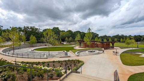 A photo of a new large park with playgrounds and pavilions under gray skies outside Atlanta. 