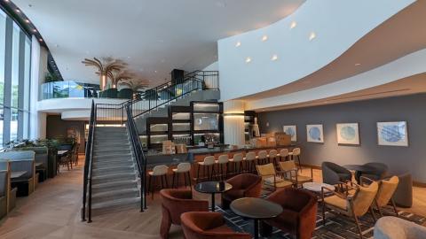 A photo of a trendy new Kimpton hotel with white walls and much art in Midtown Atlanta, with a glass exterior.