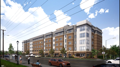 A rendering of a white and brick affordable housing building under blue skies in Atlanta.