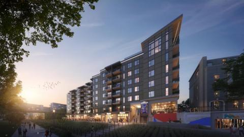 A rendering of a large new apartment building under purplish skies. 
