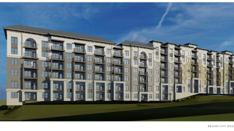 A rendering of a large beige white and brick mixed-use development under blue skies near Atlanta.