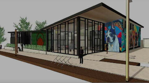 A rendering of a modern-style doggy daycare facility in Atlanta under white skies, with large candid dog murals on the sides. 