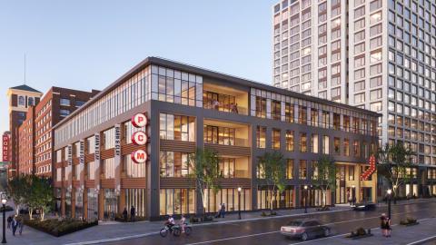 A rendering of a four story building with a lot of glass and big open offices with wood surroundings in Atlanta.