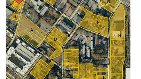 An aerial photo of parcels in yellow and a city grid near an airport. 