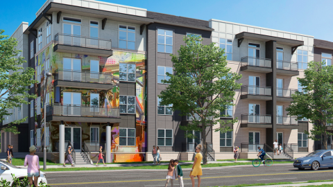 A rendering of a large new building with balconies and a street mural under blue skies. 