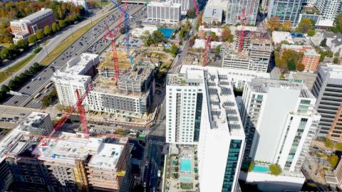 An aerial photo of a large amount of red cranes building a range of high-rises in Atlanta. 