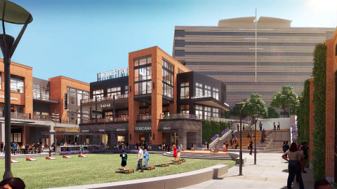 A rendering of a brick and brown development under blue skies in Dunwoody, near Atlanta and large office buildings. 