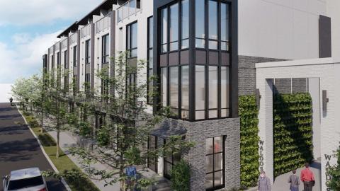 A rendering showing glass and brick townhomes with large rooftop areas under blue Atlanta skies.