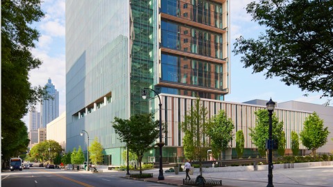 A photo of a glassy new medical building in Atlanta with vast modern interiors and trees around the base.