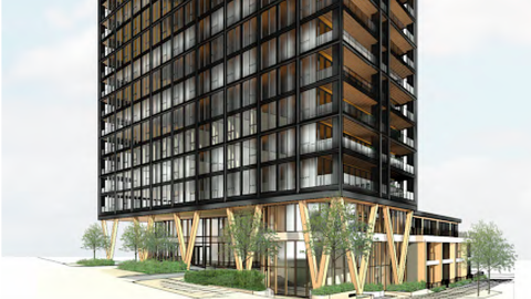 An image showing the site where a large black and wood new building is planned for a current parking lot in Atlanta.