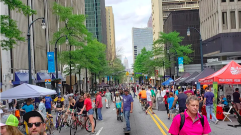 A photo of a large gathering of people in a street in downtown Atlanta. 