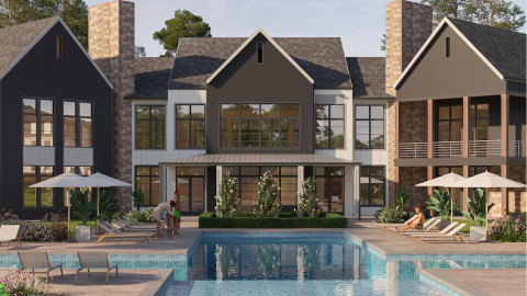 An image of an low-rise modern brown and white apartment complex next to a fancy pool with loungers.