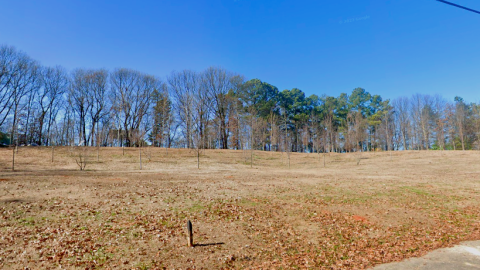 An image showing a large empty piece of land with trees around it just south of downtown Atlanta.