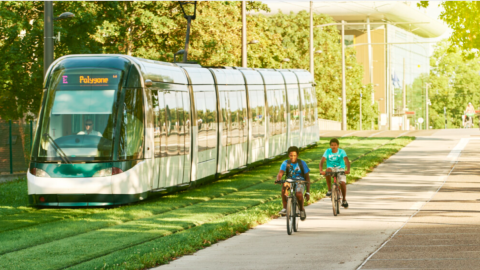 with two boys on bikes beside it, A map of a loop of trails arond Atlanta with a large transit system running around it, on a white backdrop. 