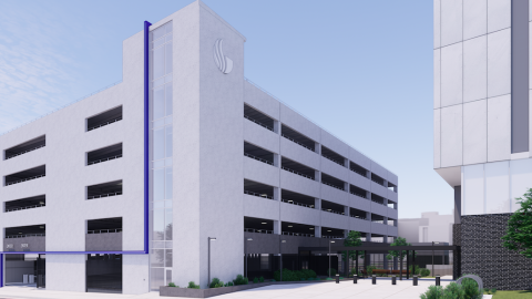 A rendering of a large gray parking deck under blue skies with a driveway beside it in Atlanta.