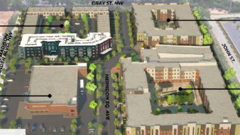An image of a development site near three large roads with brown facades and parking lots in Atlanta.