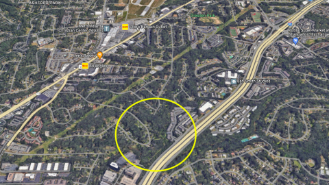 A photo of a large park site next to a wide interstate in yellow north of Atlanta.