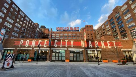 An image of a huge brick building called Ponce City Market under blue skies in Atlanta. 