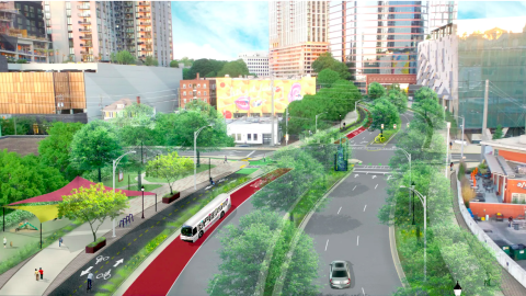 An image of a wide road in the middle of midtown Atlanta remade with new trees and greenery and bus lanes near buildings.