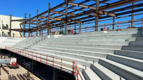 An image of a new versatile arena with concrete stairs under blue skies in Athens GA.